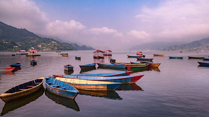 Pokhara Boats on a calm Lake Phewa at sunrise